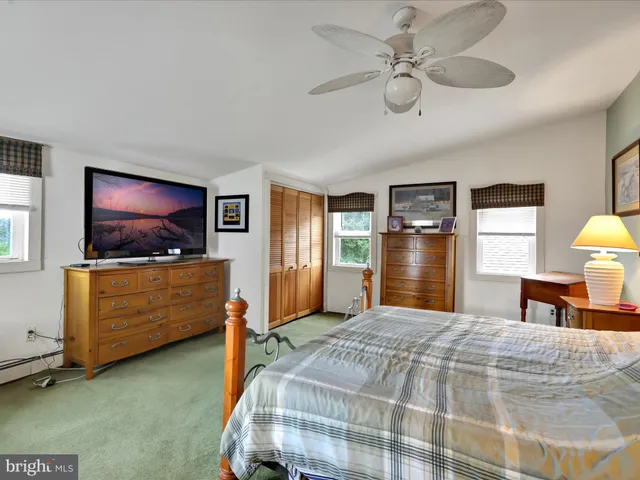 a children room with toys and a fan