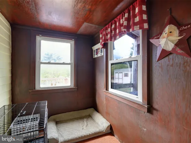 a view of a chair and table in backyard of the house