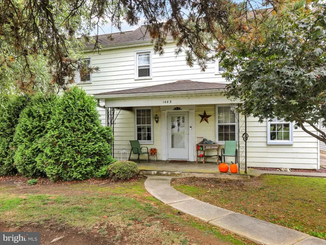 a view of a house with wooden deck and furniture