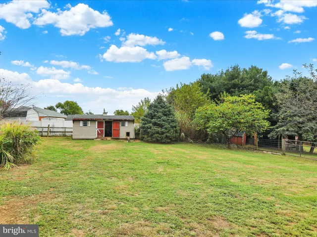 a view of a house with a yard and deck area