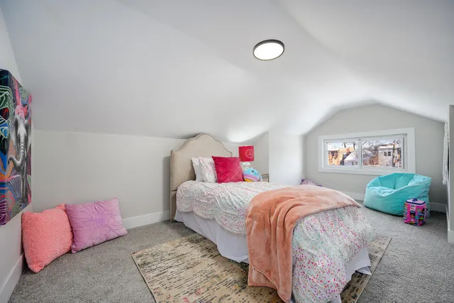 a bedroom with a bed and a couch