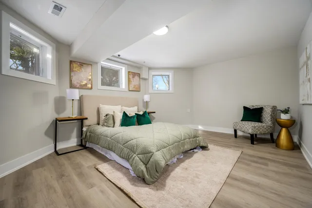 a spacious bedroom with a bed and a couch