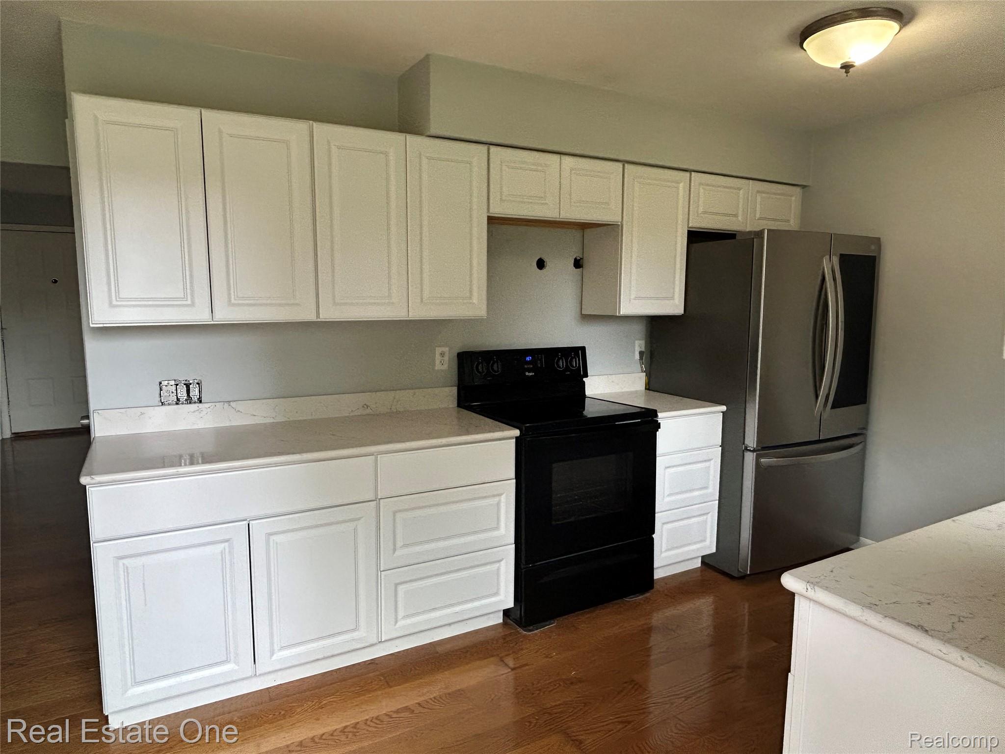2659 Benstein Road Commerce Township, MI 48382 - Photo 6 of 26 Kitchen featuring white shaker-style cabinetry, light-toned countertops, a black electric range, and a stainless steel French door refrigerator
