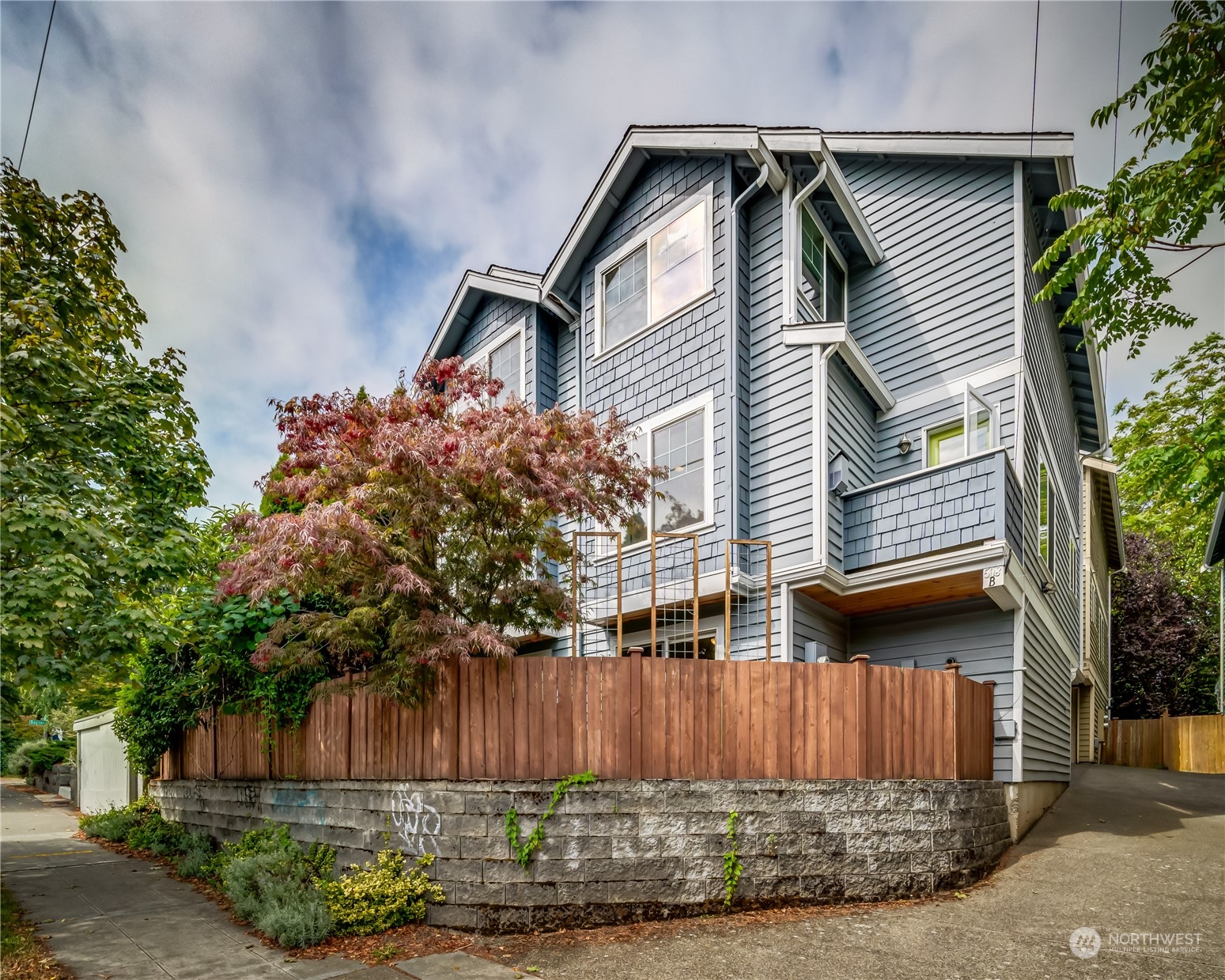508 North 46th Street, Unit B Seattle, WA 98103 - Photo 1 of 30 a front view of a house with a garden