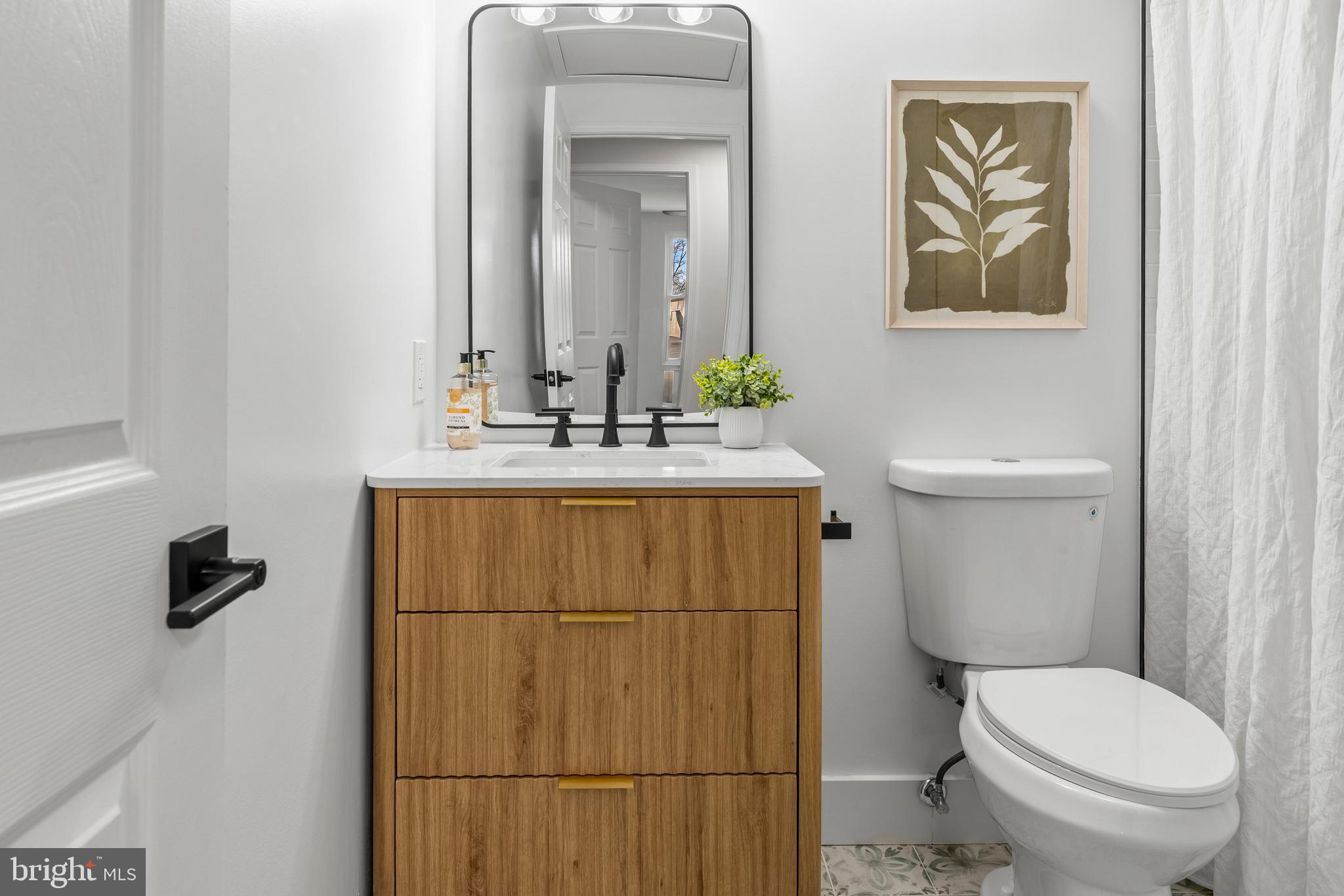 1359 Rock Chapel Road Herndon, VA 20170 - Photo 17 of 36 a bathroom with a toilet sink and mirror