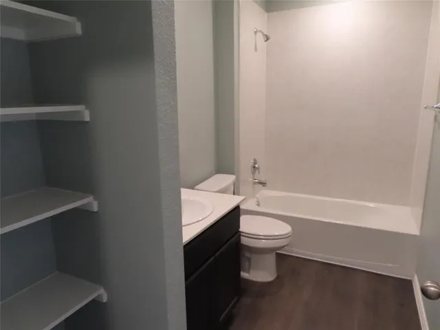 a bathroom with a white toilet and a shower