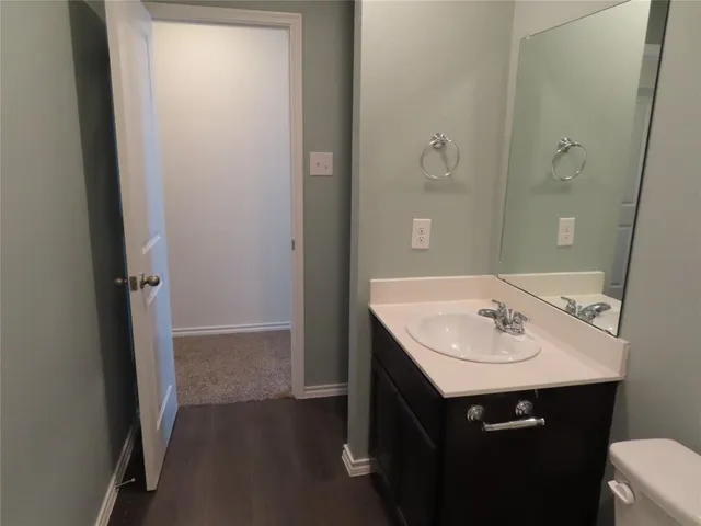 a bathroom with a sink a mirror and a toilet