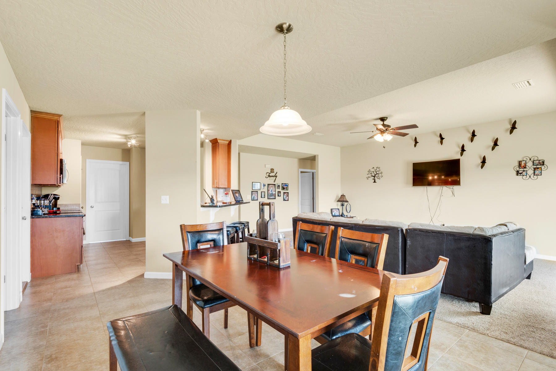 5250 Moore Loop Crestview, FL 32536 - Photo 14 of 34 a view of a dining room and livingroom with furniture wooden floor a chandelier