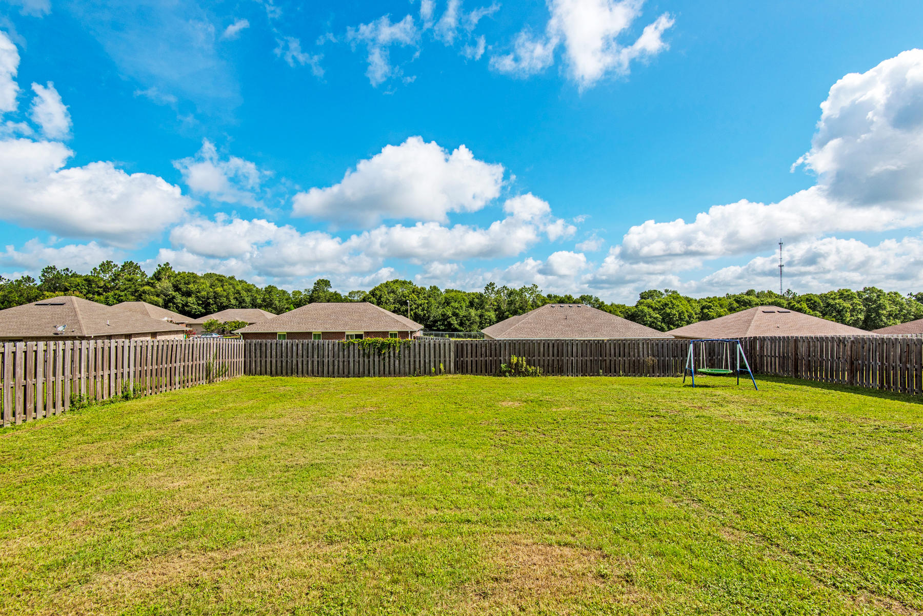 5250 Moore Loop Crestview, FL 32536 - Photo 33 of 34 a blue swimming pool is in a backyard of a house