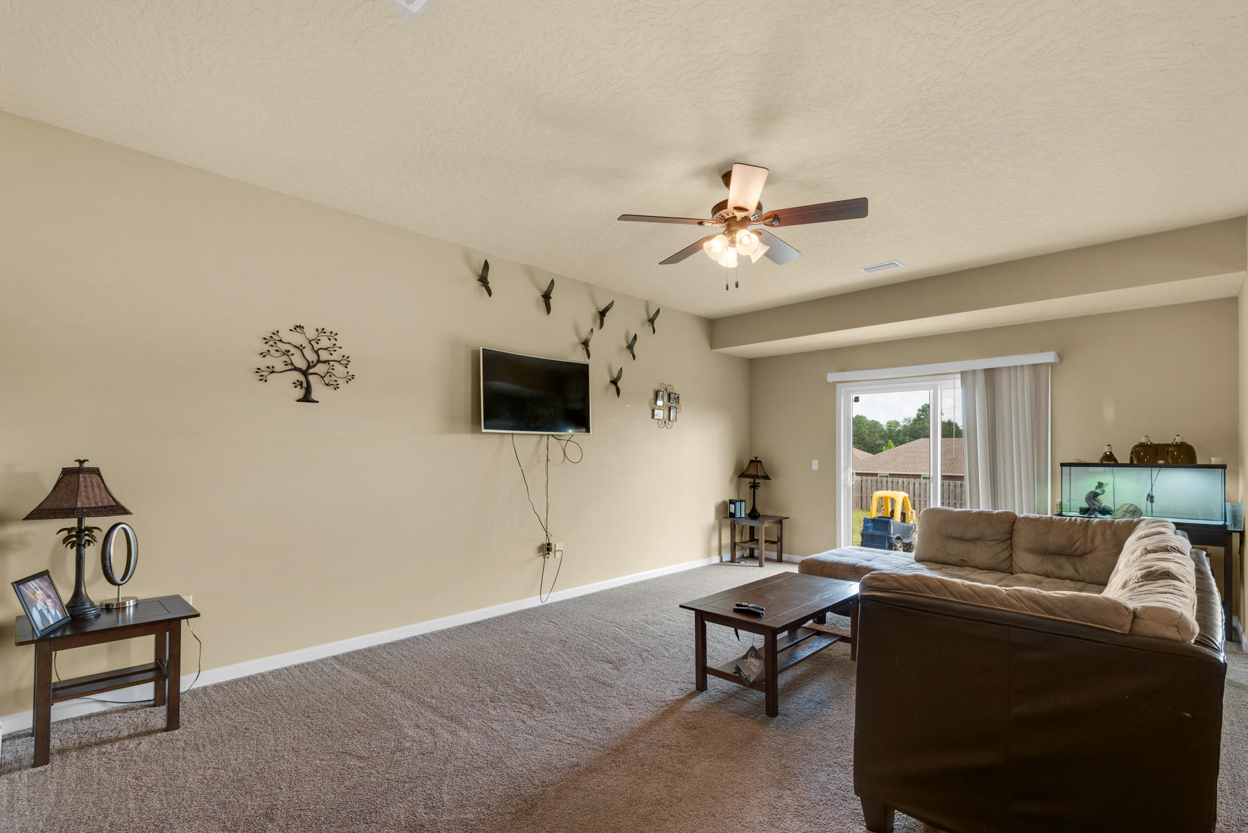 5250 Moore Loop Crestview, FL 32536 - Photo 7 of 34 a living room with furniture a flat screen tv and a window