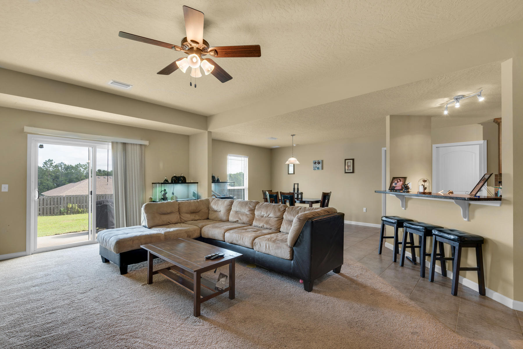 5250 Moore Loop Crestview, FL 32536 - Photo 8 of 34 a living room with furniture a table and a large window