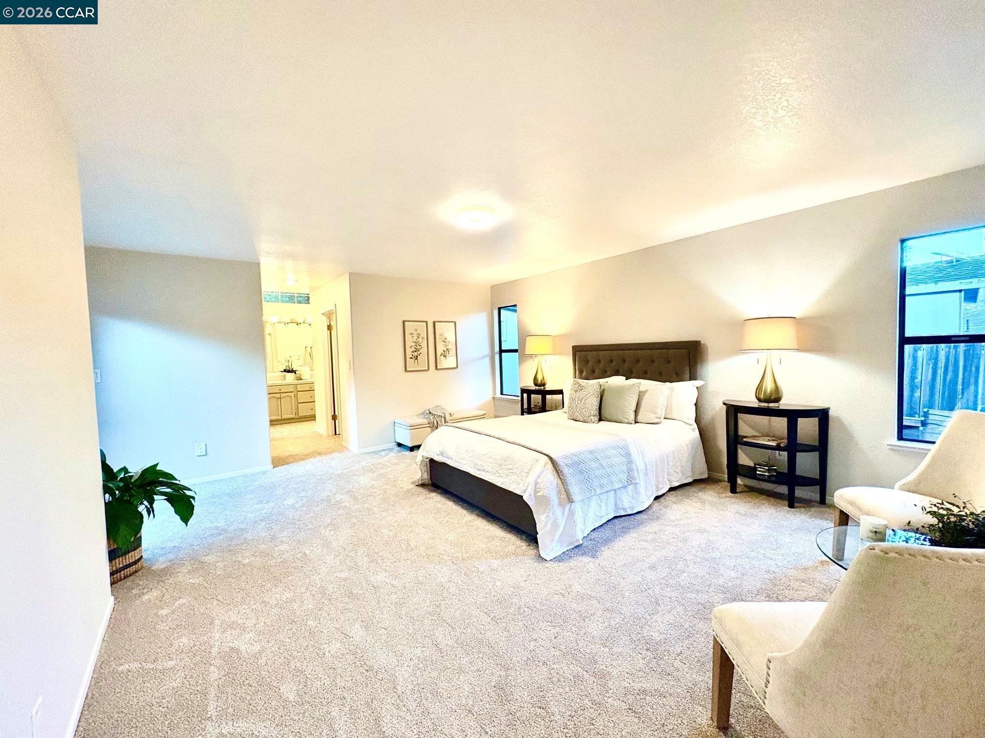 2589 Pebble Beach Loop Lafayette, CA 94549 - Photo 16 of 32 a spacious bedroom with a bed and a couch