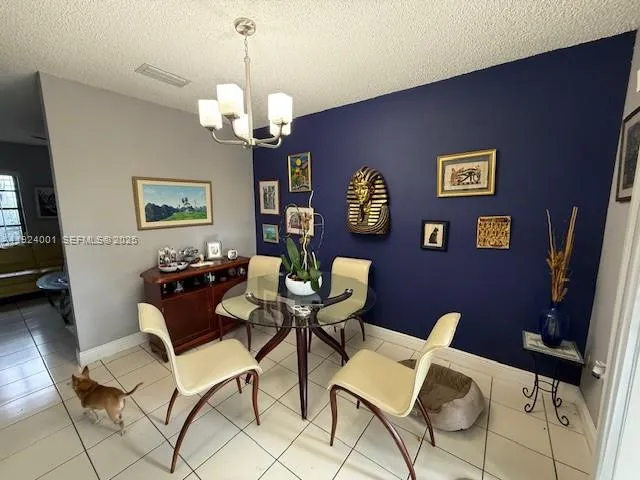 a living room with couches chairs and a flat screen tv