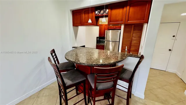 a view of a dining room with furniture and window