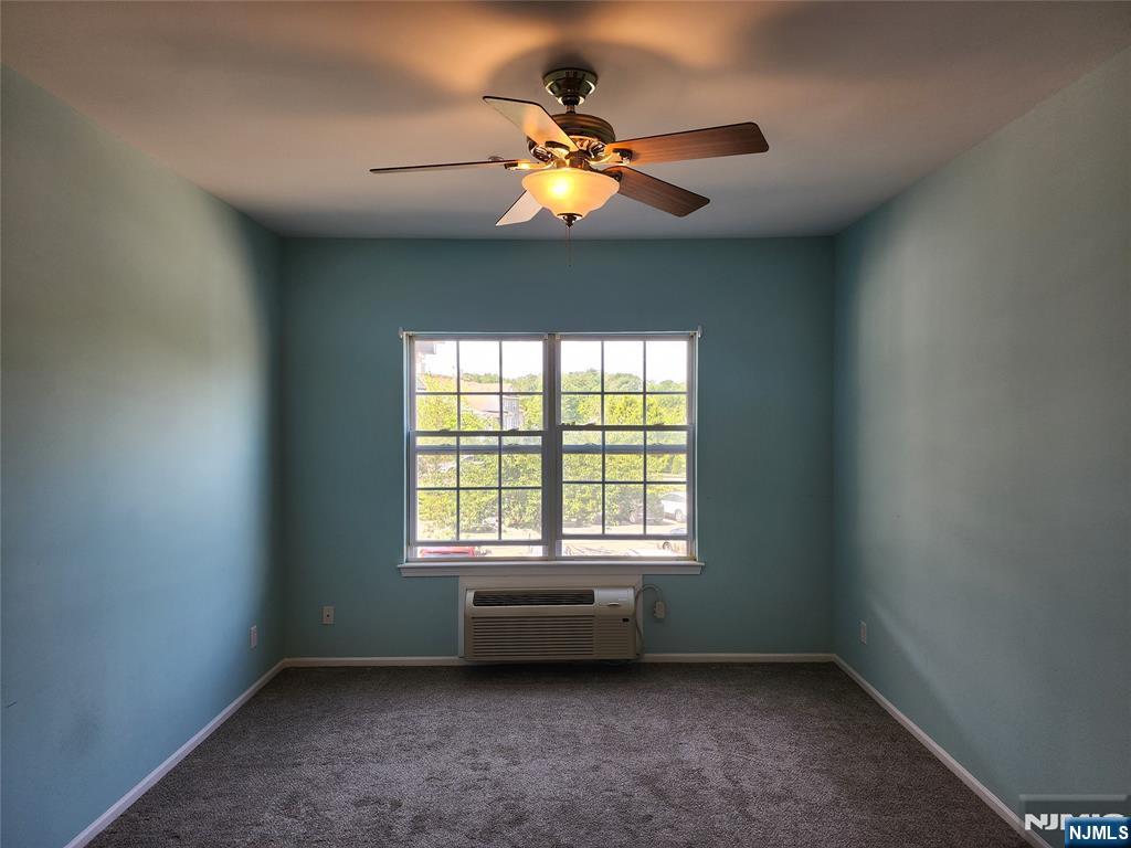 9212 Richmond Road West Milford, NJ 07480 - Photo 4 of 16 an empty room with a window and a ceiling fan