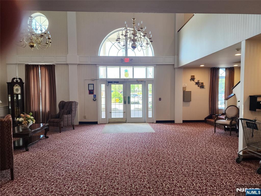 9212 Richmond Road West Milford, NJ 07480 - Photo 10 of 16 a living room with furniture a chandelier and a large window