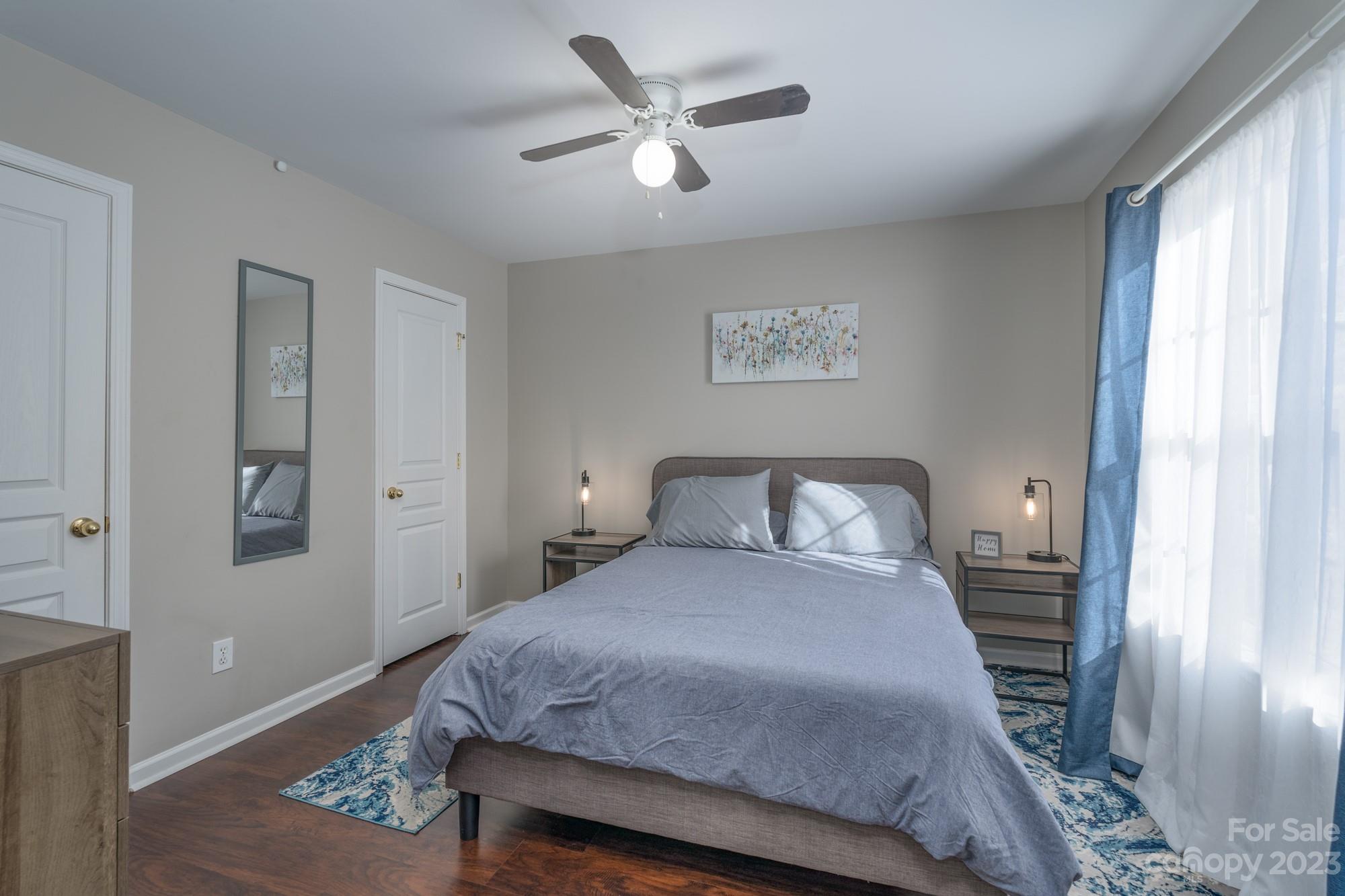 4841 Elizabeth Road Charlotte, NC 28269 - Photo 9 of 20 a bedroom with a large bed and a chandelier