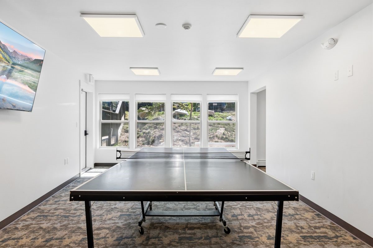 89410 Ryan Gulch Road, Unit 208 Silverthorne, CO 80498 - Photo 22 of 30 a view of a room with a table and chairs