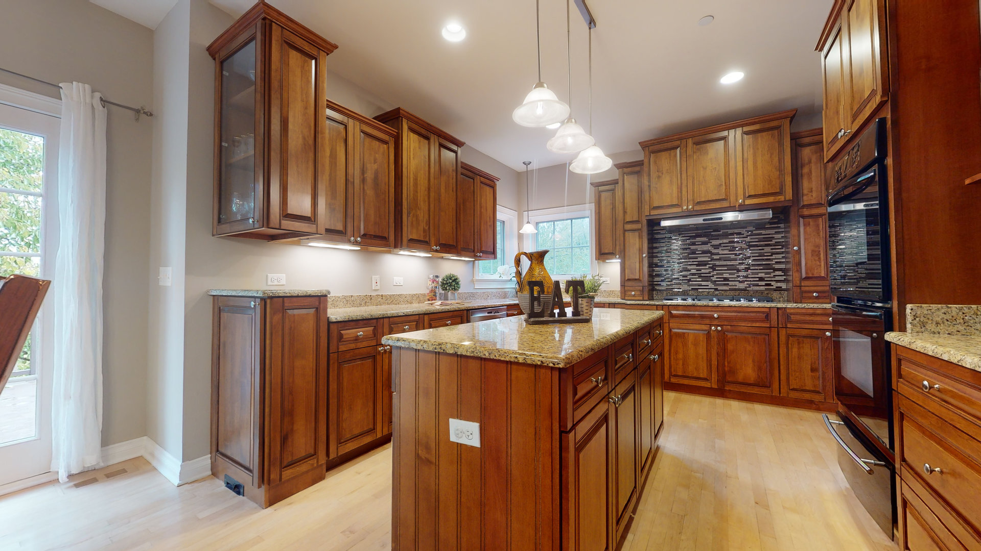 6344 Gilmer Road Long Grove, IL 60047 - Photo 14 of 43 a kitchen with stainless steel appliances granite countertop a sink a stove and a refrigerator