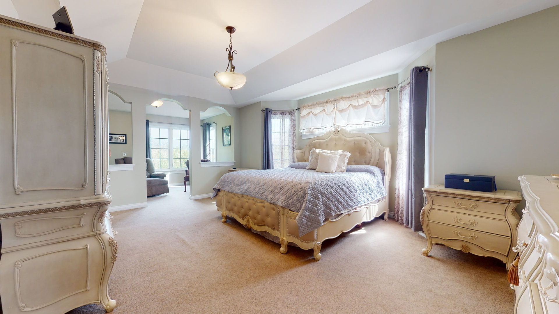 6344 Gilmer Road Long Grove, IL 60047 - Photo 18 of 43 a spacious bedroom with a bed a chandelier and large window