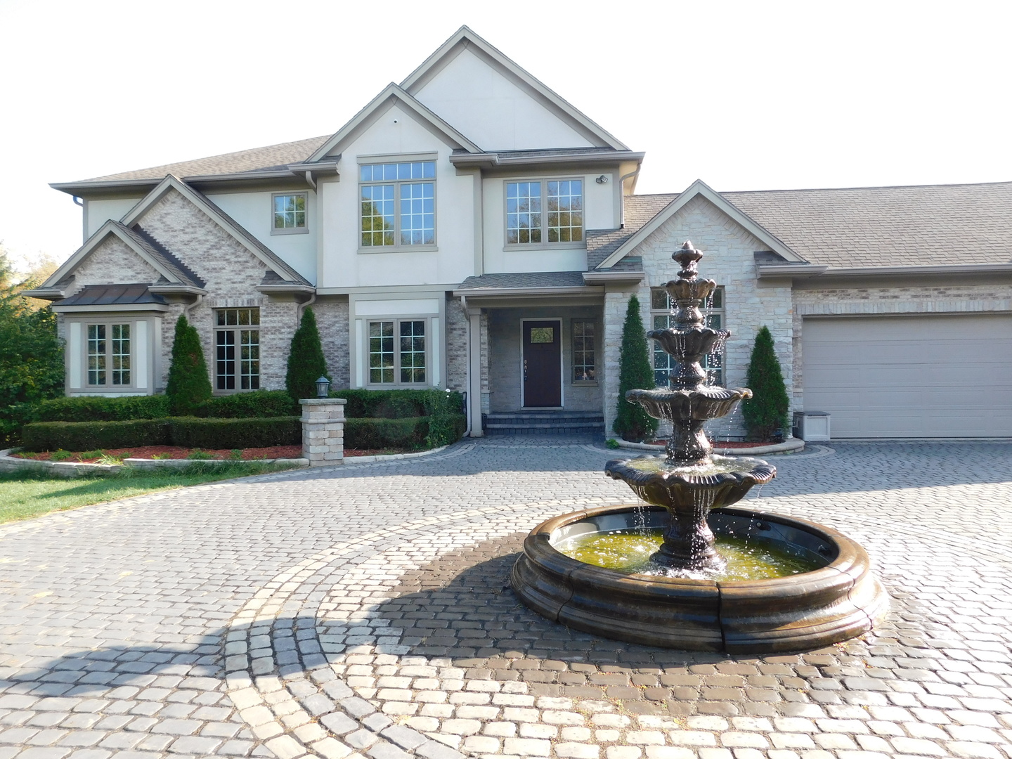 6344 Gilmer Road Long Grove, IL 60047 - Photo 2 of 43 a front view of a house with a yard fire pit and outdoor seating