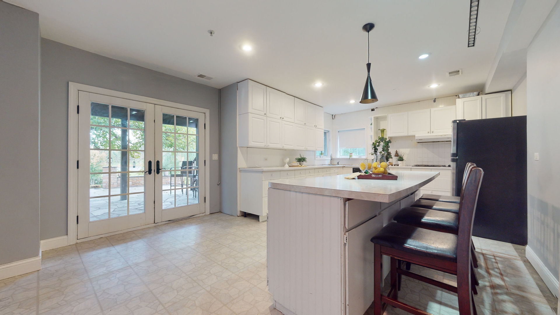 6344 Gilmer Road Long Grove, IL 60047 - Photo 28 of 43 a kitchen with a table chairs refrigerator and microwave
