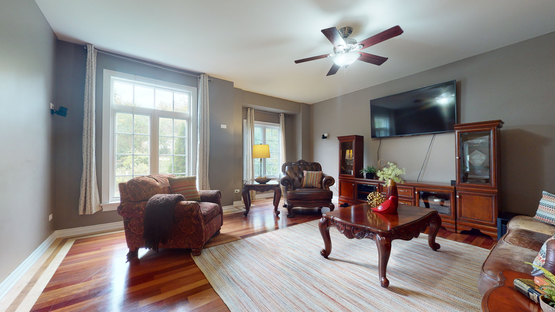 6344 Gilmer Road Long Grove, IL 60047 - Photo 8 of 43 a living room with furniture a flat screen tv and a large window