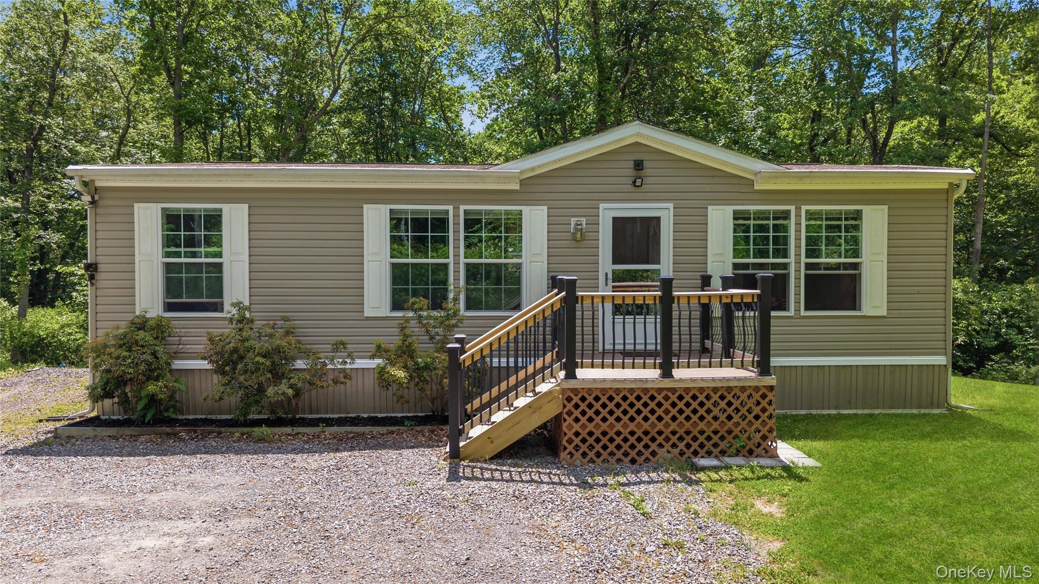 239-241 Fosler Road Highland, NY 12528 - Photo 28 of 42 Exterior featuring tan siding, white window shutters, and a front porch with black railing