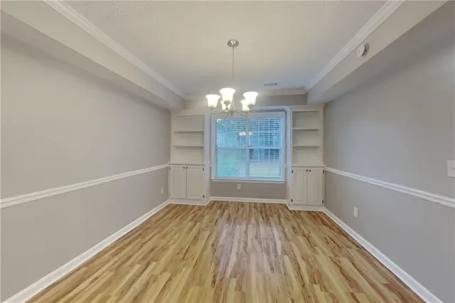 a view of a room with wooden floor and window