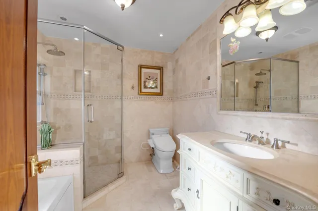 a bathroom with a granite countertop sink mirror and a shower