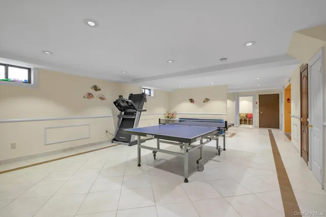 a room with furniture pool table and windows