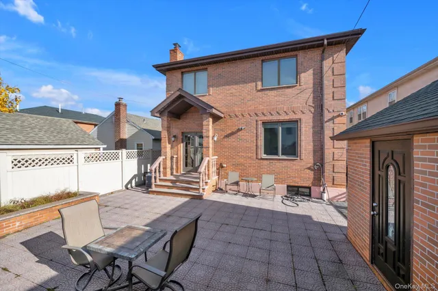 a backyard of a house with barbeque oven table and chairs