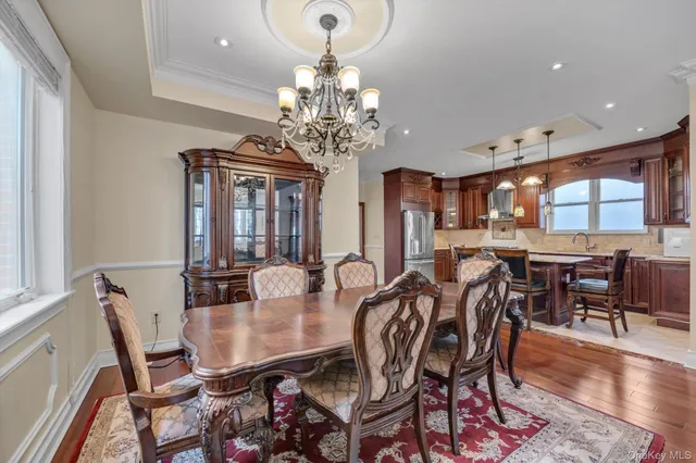 a view of a dining room with furniture and chandelier