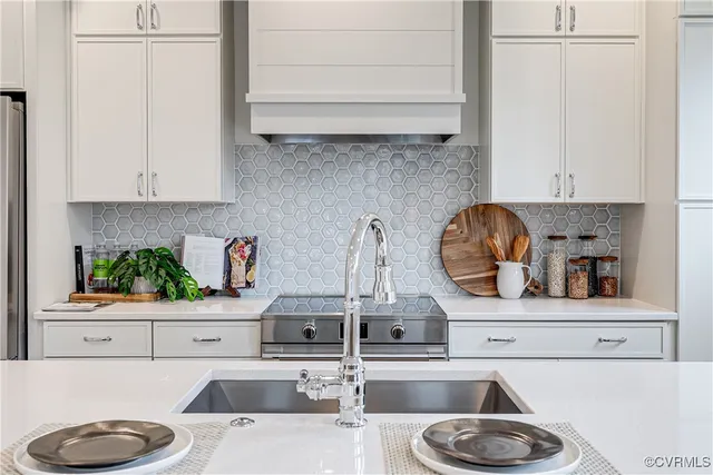 a kitchen with a sink a stove and a refrigerator with wooden floor