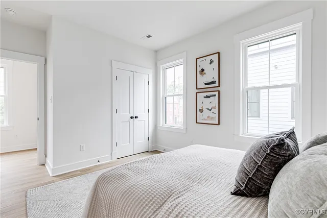 a bedroom with a bed and a window