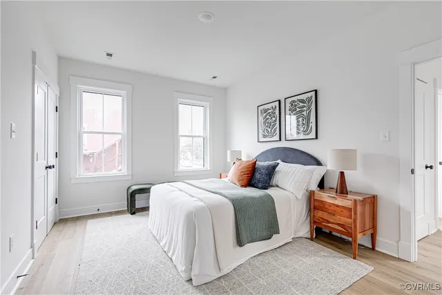 a bedroom with a large bed and a window