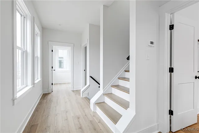 a view of entryway with wooden floor and staircase