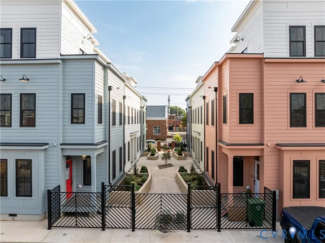 a view of a brick house with many windows