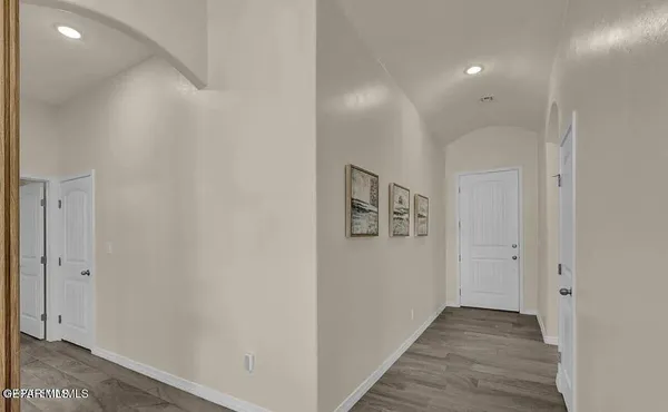 a view of a hallway with wooden floor