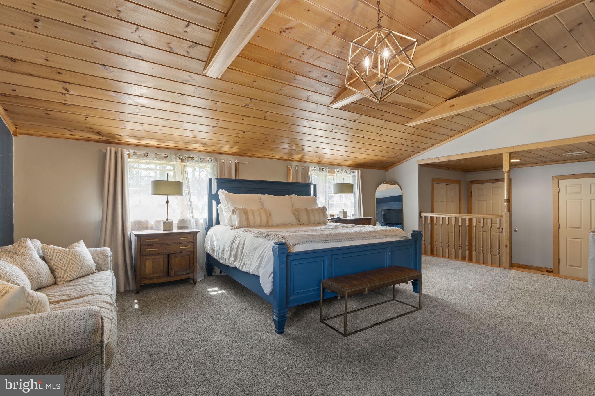 1017 Scholl Road Pottstown, PA 19465 - Photo 24 of 56 a bedroom with a bed and a chandelier