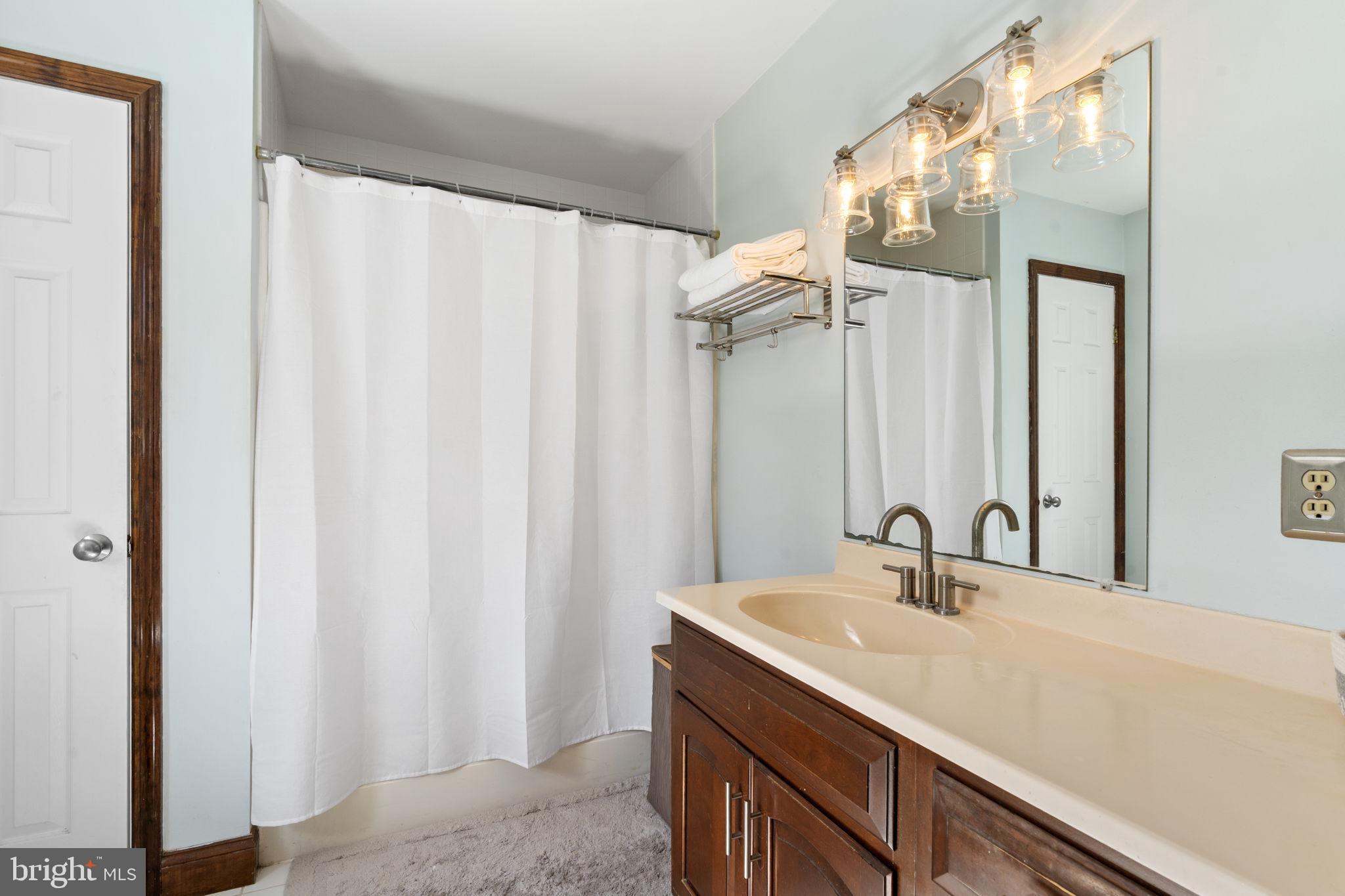 1017 Scholl Road Pottstown, PA 19465 - Photo 29 of 56 a bathroom with a double vanity sink and mirror