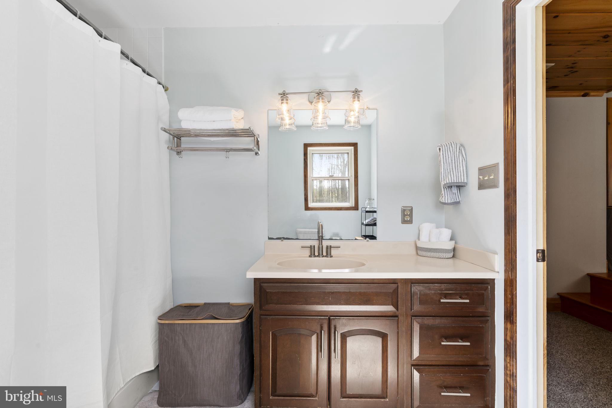 1017 Scholl Road Pottstown, PA 19465 - Photo 31 of 56 a en suite bathroom with a granite countertop sink and a mirror