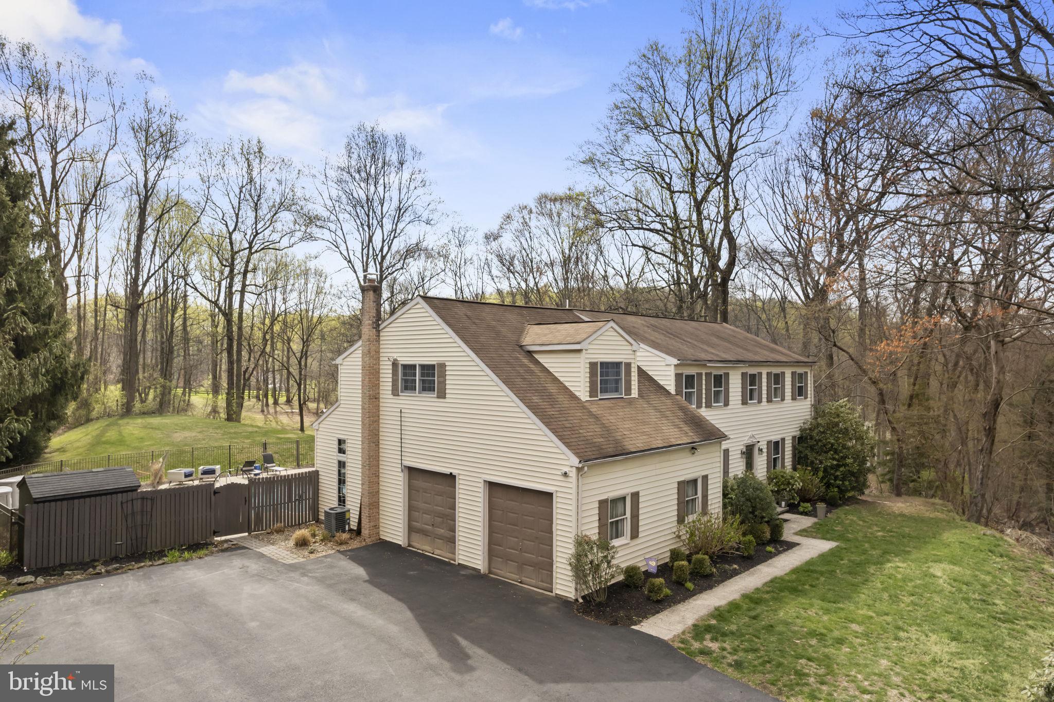 1017 Scholl Road Pottstown, PA 19465 - Photo 51 of 56 a view of a white house next to a yard with trees