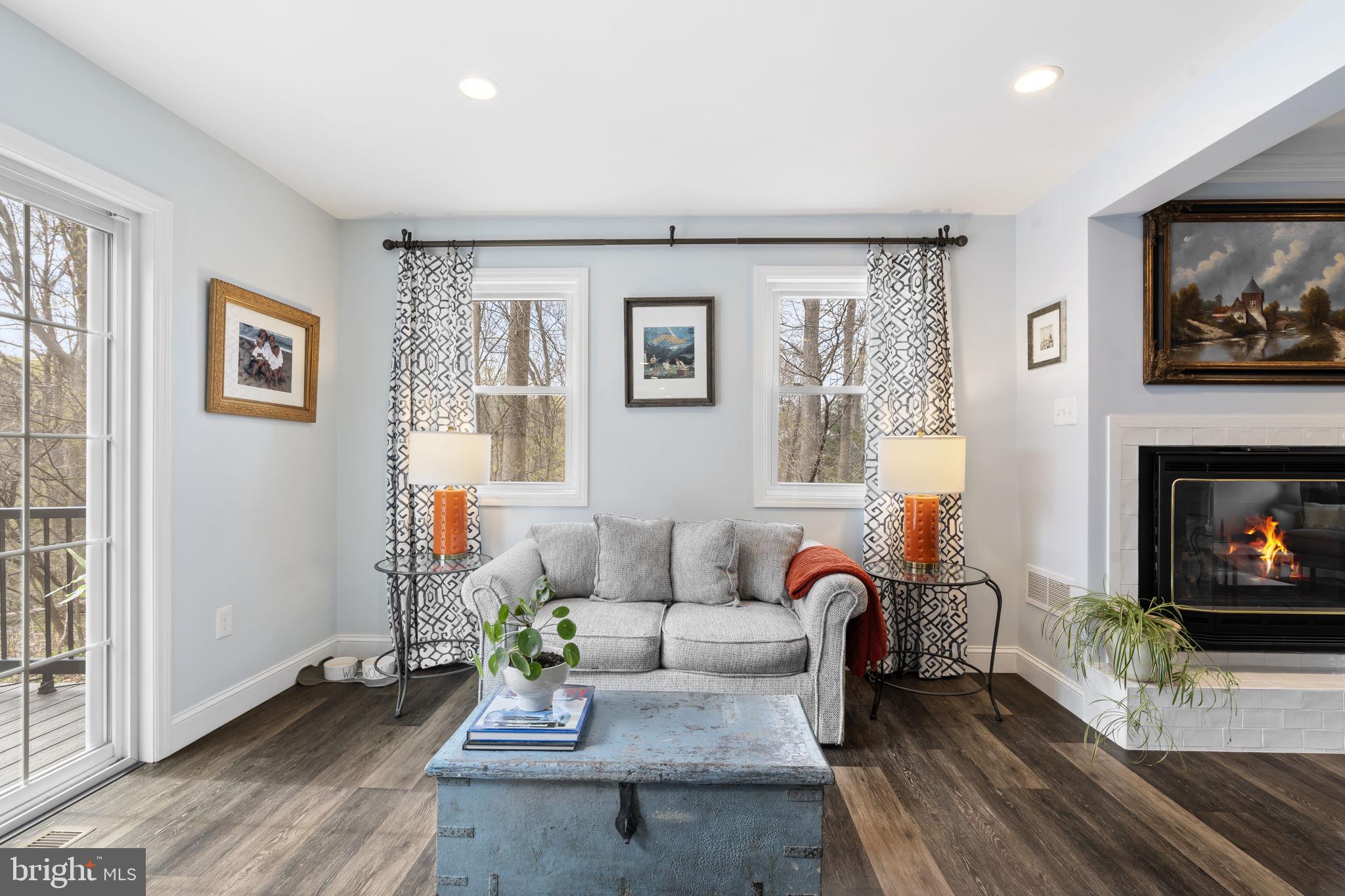 1017 Scholl Road Pottstown, PA 19465 - Photo 6 of 56 a living room with furniture a flat screen tv and a fireplace