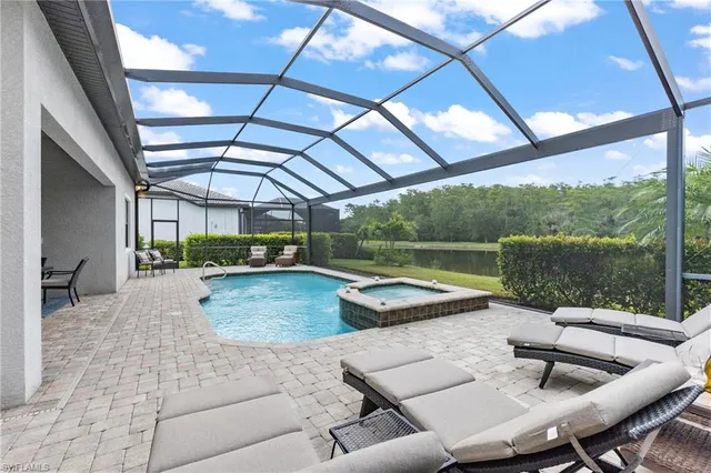 a view of swimming pool with a table and chairs