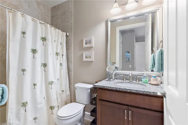 a kitchen with stainless steel appliances granite countertop a stove top oven a sink dishwasher a dining table and chairs with wooden floor