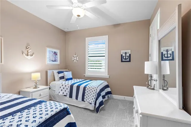 a bedroom with two beds and a chandelier