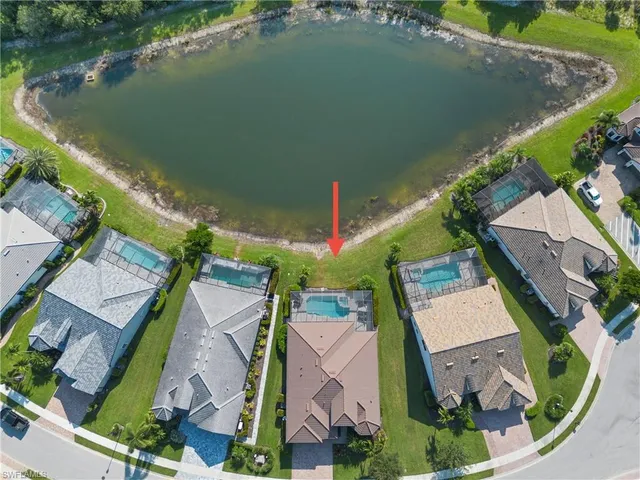an aerial view of a house with a lake view