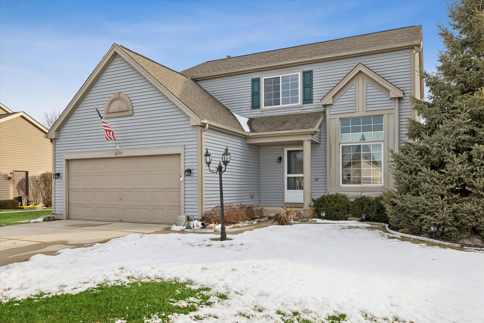 1157 Sawmill Lane Algonquin, IL 60102 - Photo 1 of 22 a front view of a house with a yard and garage