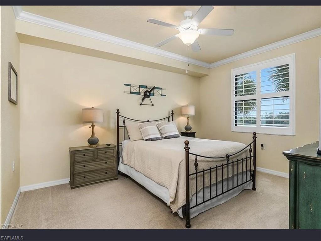 9566 Trevi Court, Unit 4935 Naples, FL 34113 - Photo 11 of 20 a bedroom with a bed and a table